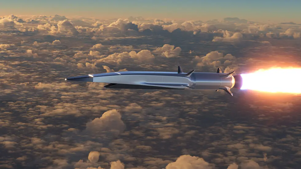 A missile with ignited propulsion flying at high altitude among clouds during sunset